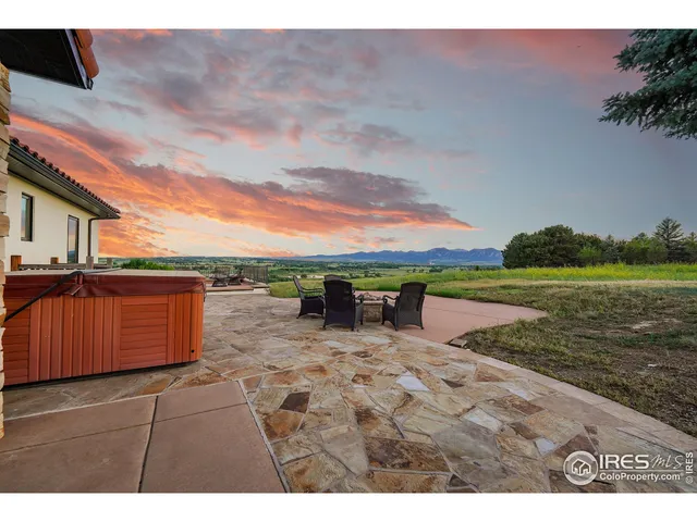 a view of lounge chair on wooden deck with lake view