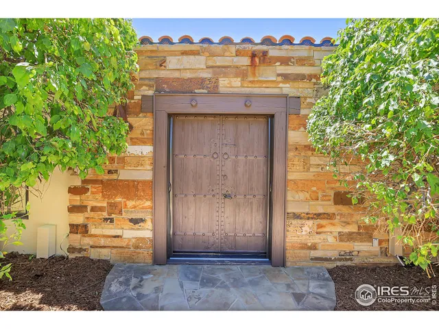 a living room with furniture a chandelier and a rug