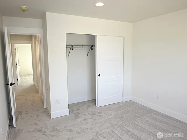 a view of a room with a hallway and a refrigerator