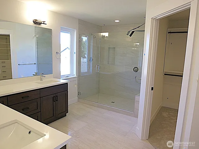 a bathroom with a shower sink and mirror
