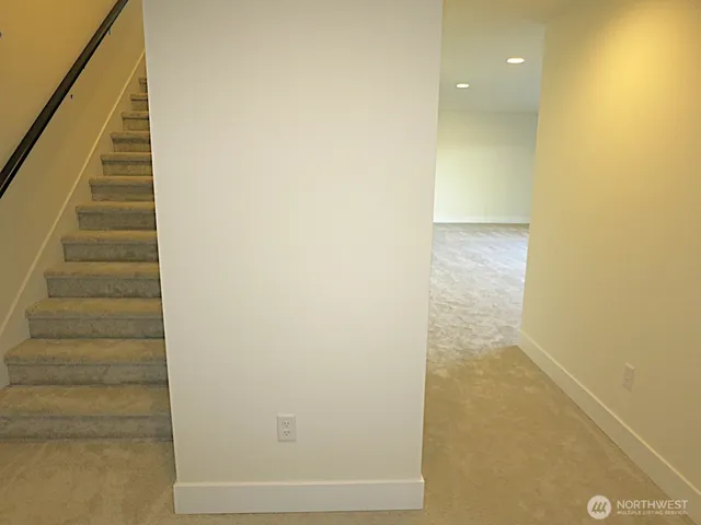 a view of a hallway with stairs
