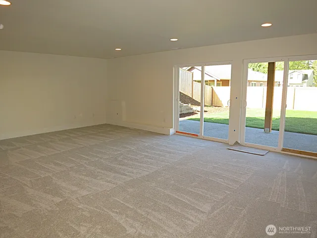 an empty room with large windows