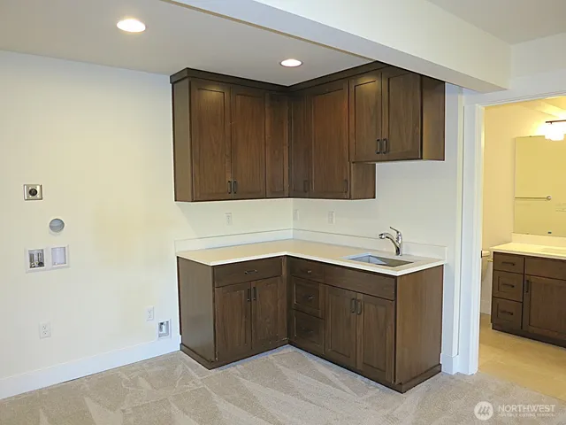 a kitchen with a sink cabinets and utility