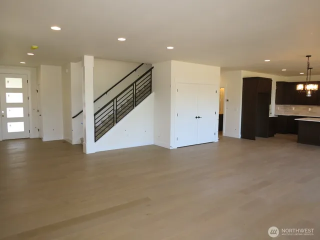 a view of an empty room with stairs and ventilation