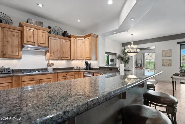 a kitchen with granite countertop a sink and a counter top space