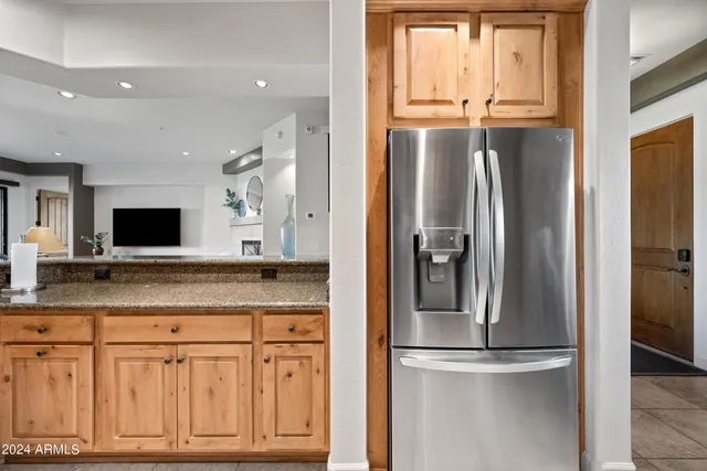 a bedroom with a large window and a balcony