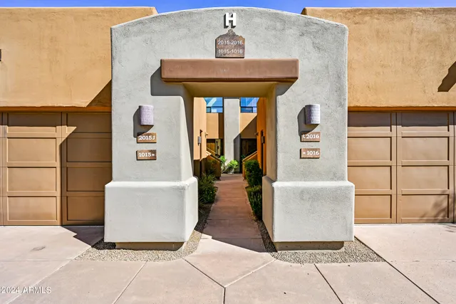 a living room with couches and a table with rug
