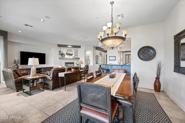 a spacious bathroom with a granite countertop double vanity sink a mirror a bathtub and window