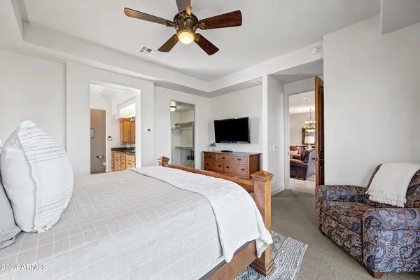 a bedroom with a bed and a chandelier