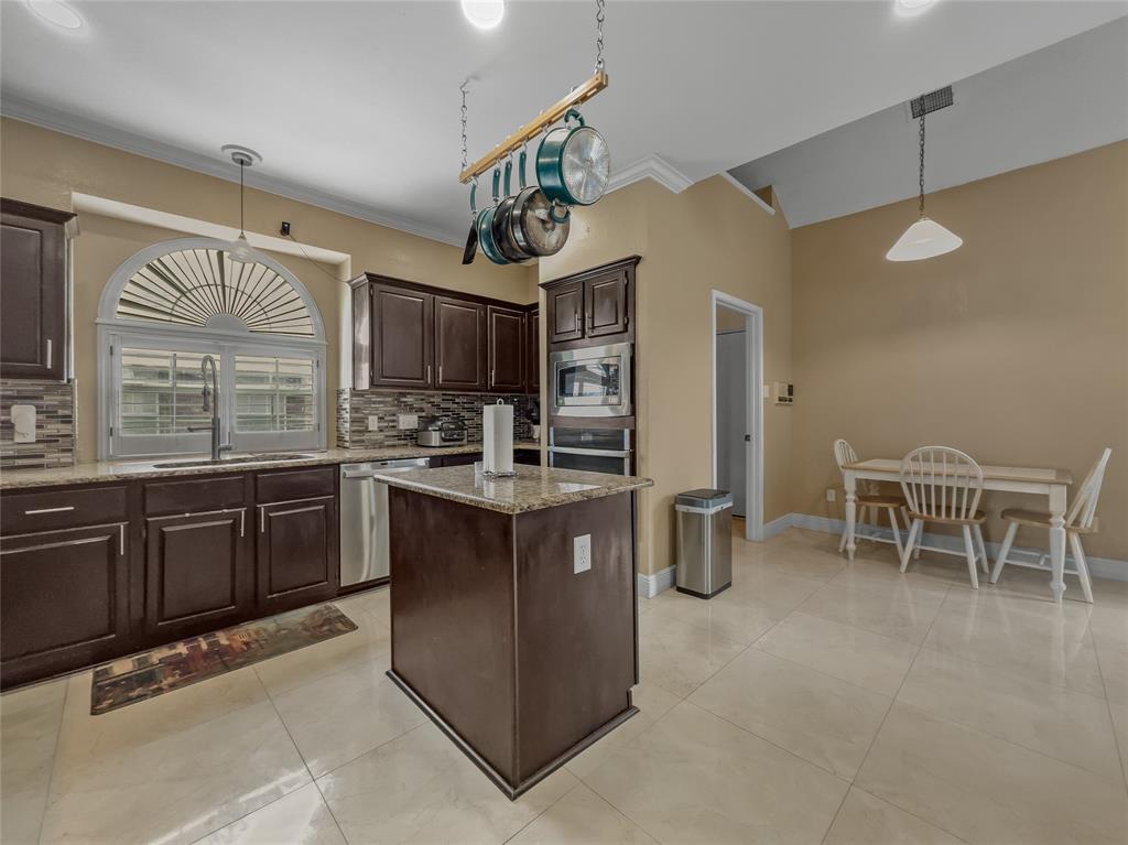 2317 Wellesly Road Rowlett, TX 75089 - Photo 6 of 39 a kitchen with stainless steel appliances granite countertop a sink refrigerator and cabinets