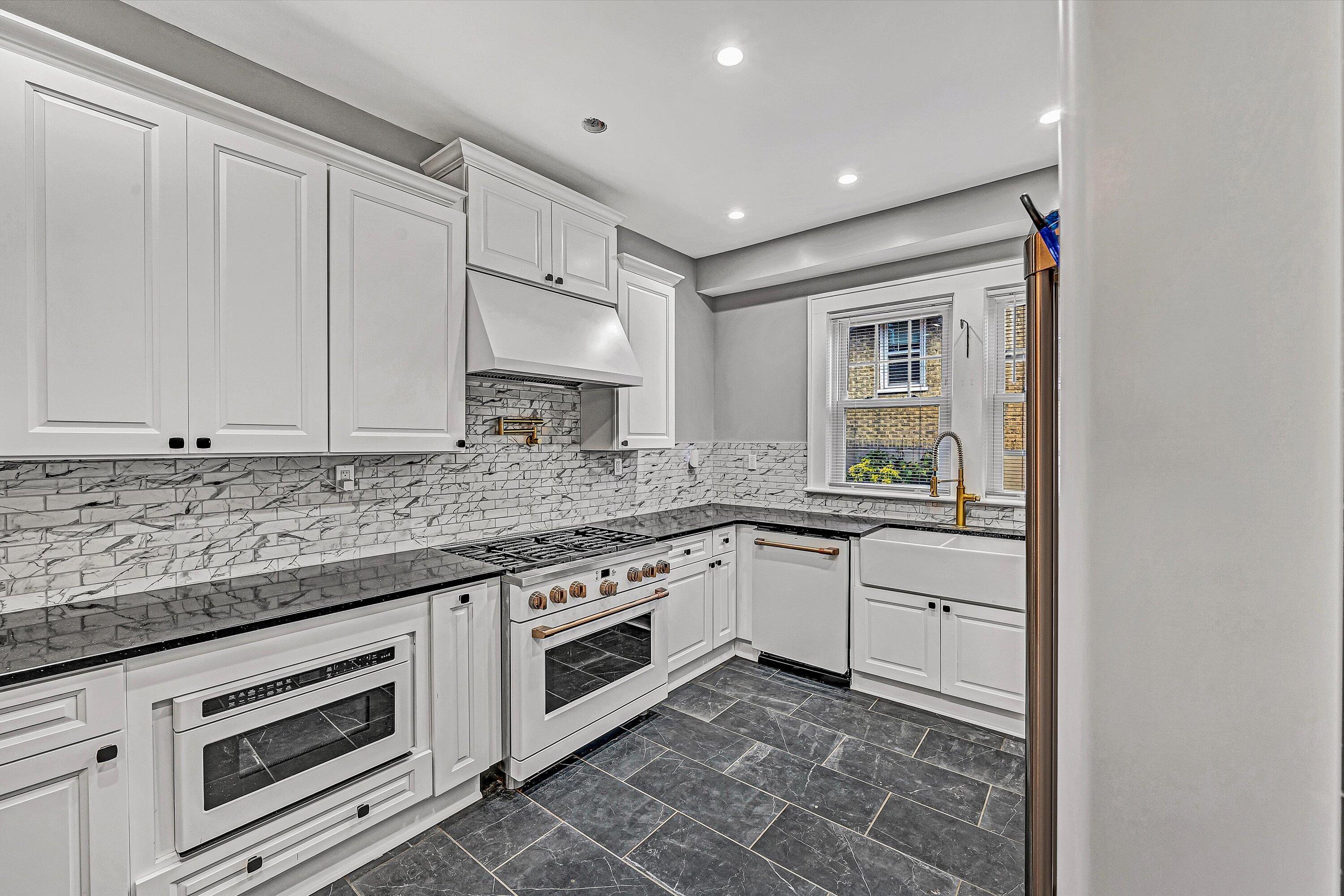 1725 Arlington Road Southwest Roanoke, VA 24015 - Photo 11 of 44 a kitchen with granite countertop white cabinets and white appliances