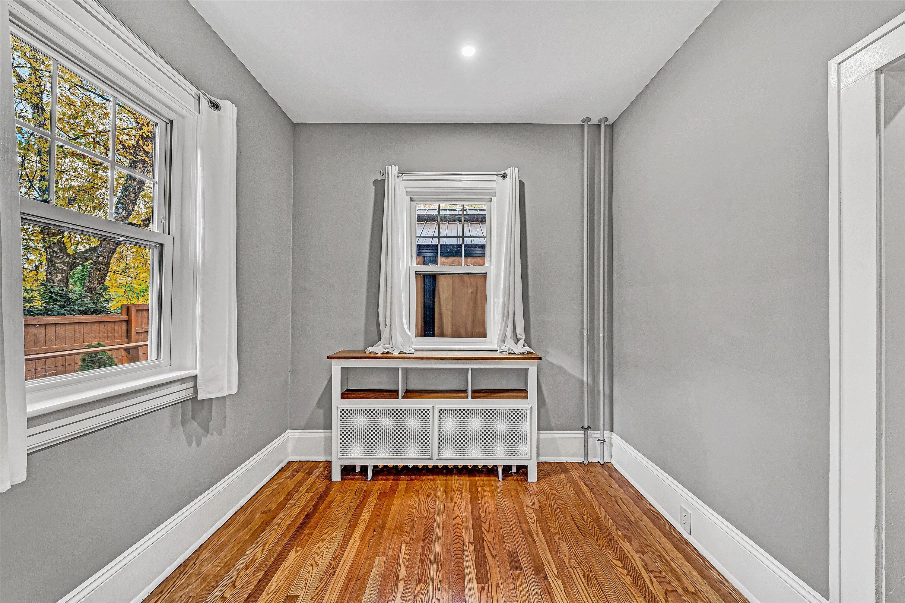 1725 Arlington Road Southwest Roanoke, VA 24015 - Photo 17 of 44 a view of an empty room with wooden floor and a window
