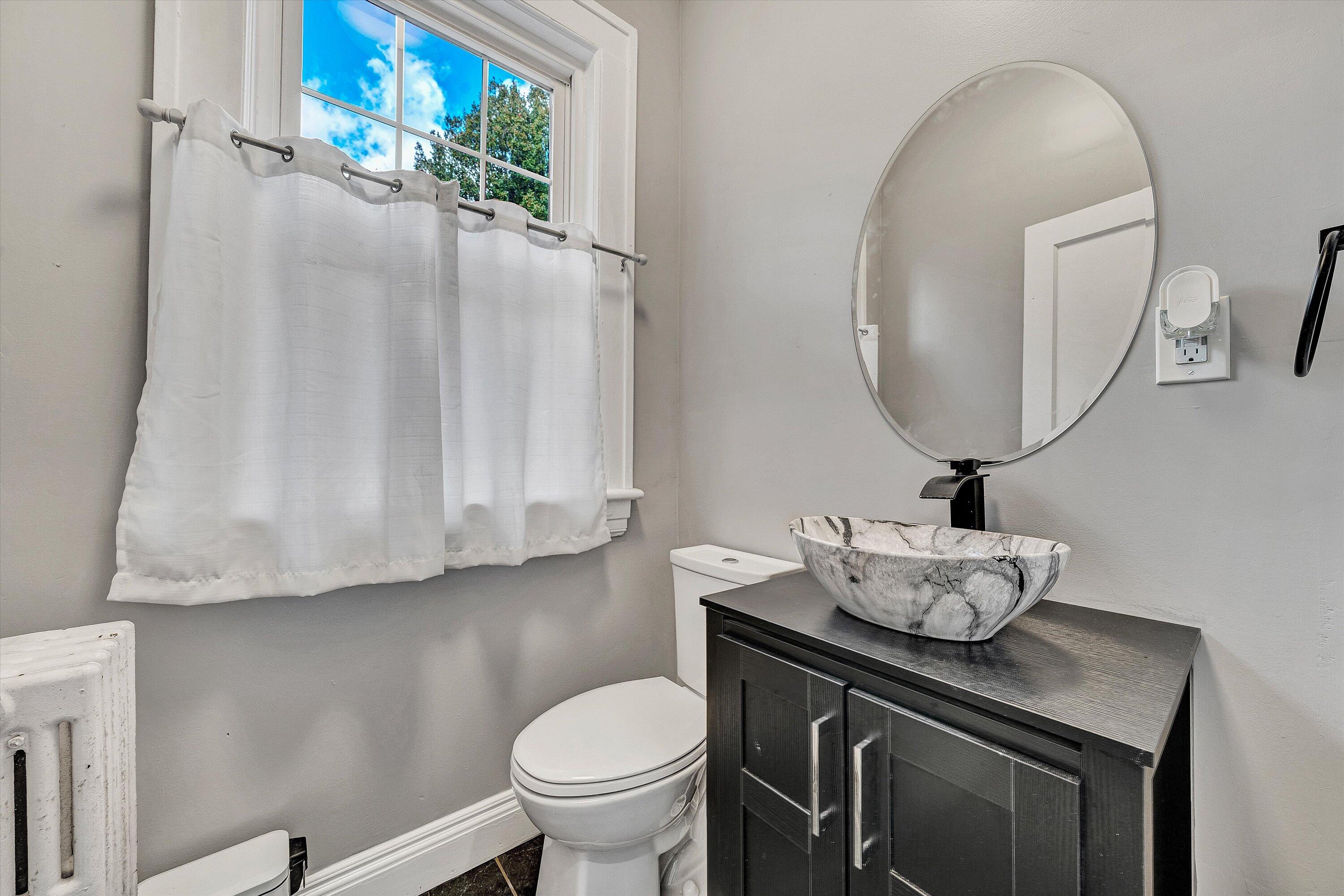 1725 Arlington Road Southwest Roanoke, VA 24015 - Photo 18 of 44 a bathroom with a sink a toilet and mirror