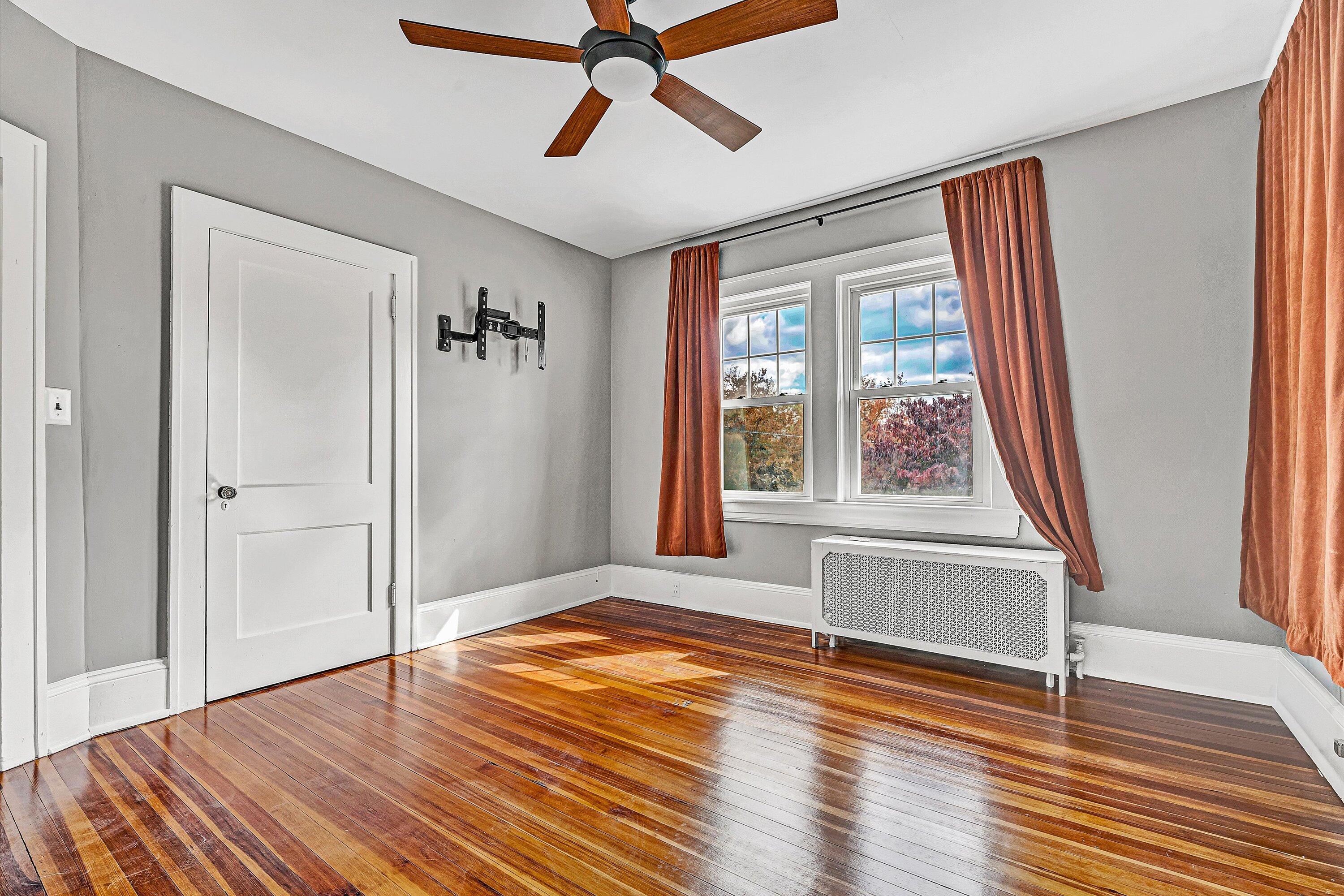 1725 Arlington Road Southwest Roanoke, VA 24015 - Photo 22 of 44 a view of an empty room with wooden floor and a window