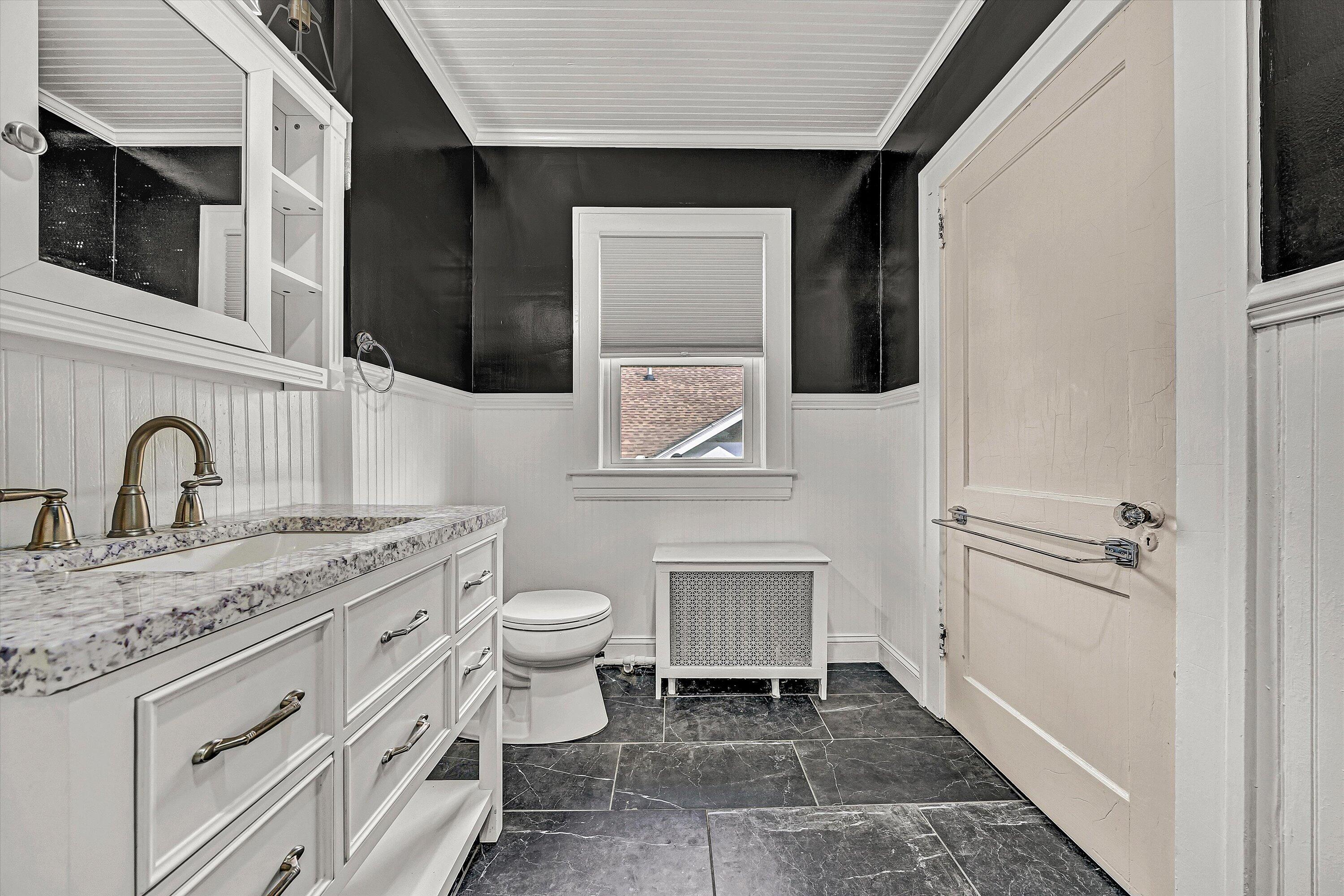 1725 Arlington Road Southwest Roanoke, VA 24015 - Photo 29 of 44 a bathroom with a toilet a sink and mirror
