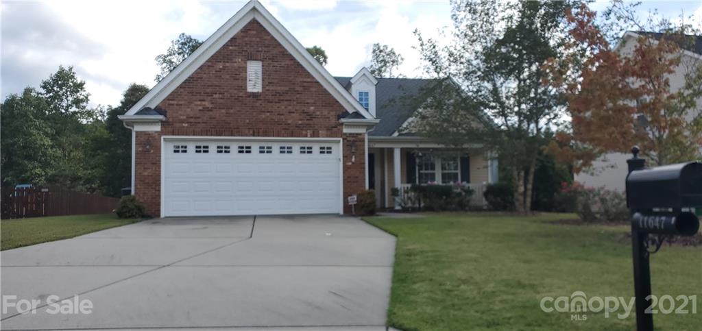 11647 Tucker Field Road Midland, NC 28107 - Photo 2 of 30 a front view of a house with a yard and garage