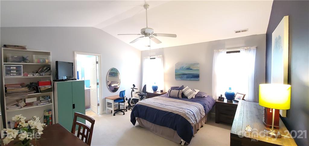 11647 Tucker Field Road Midland, NC 28107 - Photo 13 of 30 a bedroom with a bed and a chandelier