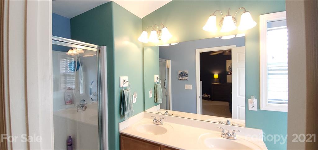 11647 Tucker Field Road Midland, NC 28107 - Photo 15 of 30 a bathroom with a sink tub and shower