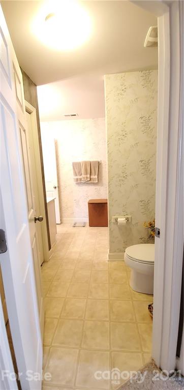 11647 Tucker Field Road Midland, NC 28107 - Photo 18 of 30 a bathroom with a granite countertop shower a sink and a toilet