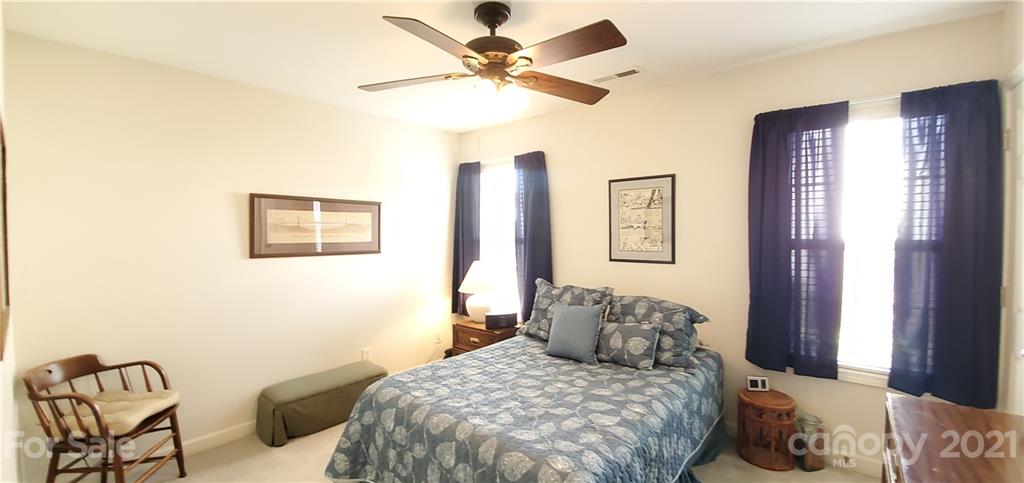 11647 Tucker Field Road Midland, NC 28107 - Photo 19 of 30 a bedroom with a bed and a chandelier
