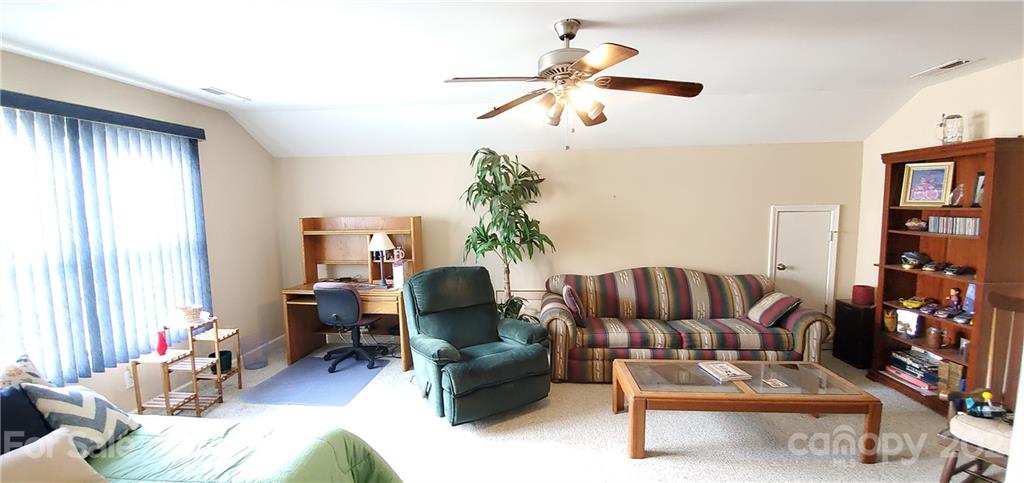 11647 Tucker Field Road Midland, NC 28107 - Photo 23 of 30 a living room with furniture ceiling fan and a window