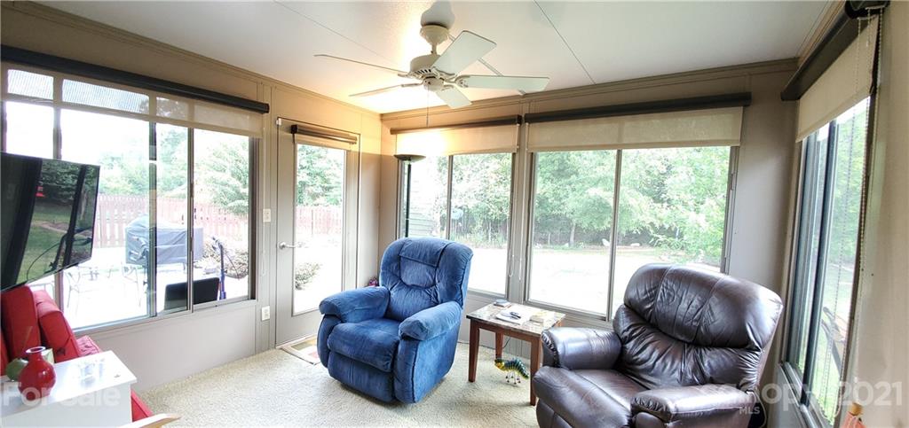 11647 Tucker Field Road Midland, NC 28107 - Photo 24 of 30 a living room with furniture and a floor to ceiling window