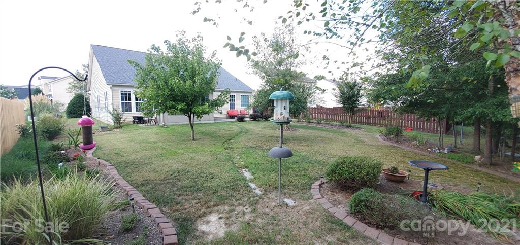 11647 Tucker Field Road Midland, NC 28107 - Photo 29 of 30 a backyard of a house with table and chairs