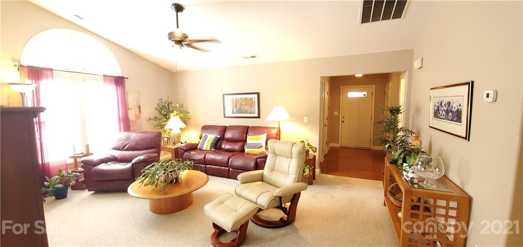 11647 Tucker Field Road Midland, NC 28107 - Photo 4 of 30 a living room with furniture and a chandelier