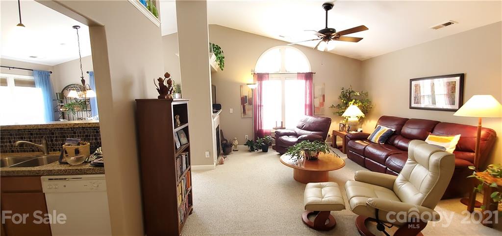 11647 Tucker Field Road Midland, NC 28107 - Photo 6 of 30 a living room with furniture a chandelier and a window