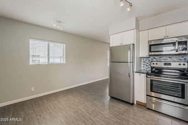 a view of a kitchen with a refrigerator a stove top oven and a refrigerator