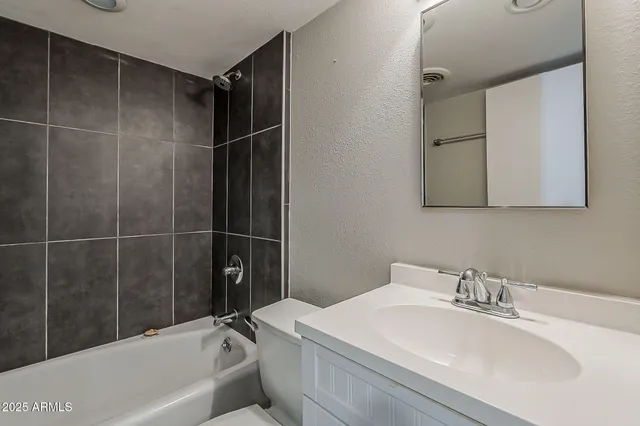 a bathroom with a sink a mirror and a bathtub