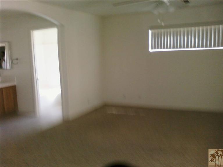 13700 El Rio Lane Desert Hot Springs, CA 92240 - Photo 5 of 9 wooden floor in a hall with a window
