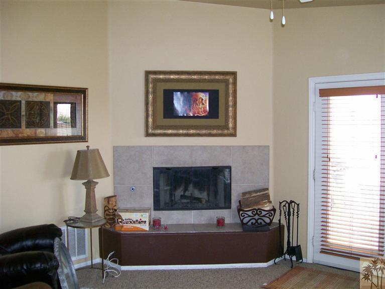 13700 El Rio Lane Desert Hot Springs, CA 92240 - Photo 6 of 9 a living room with furniture and a fireplace
