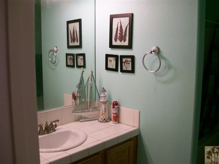 13700 El Rio Lane Desert Hot Springs, CA 92240 - Photo 7 of 9 a bathroom with a sink vanity and a mirror