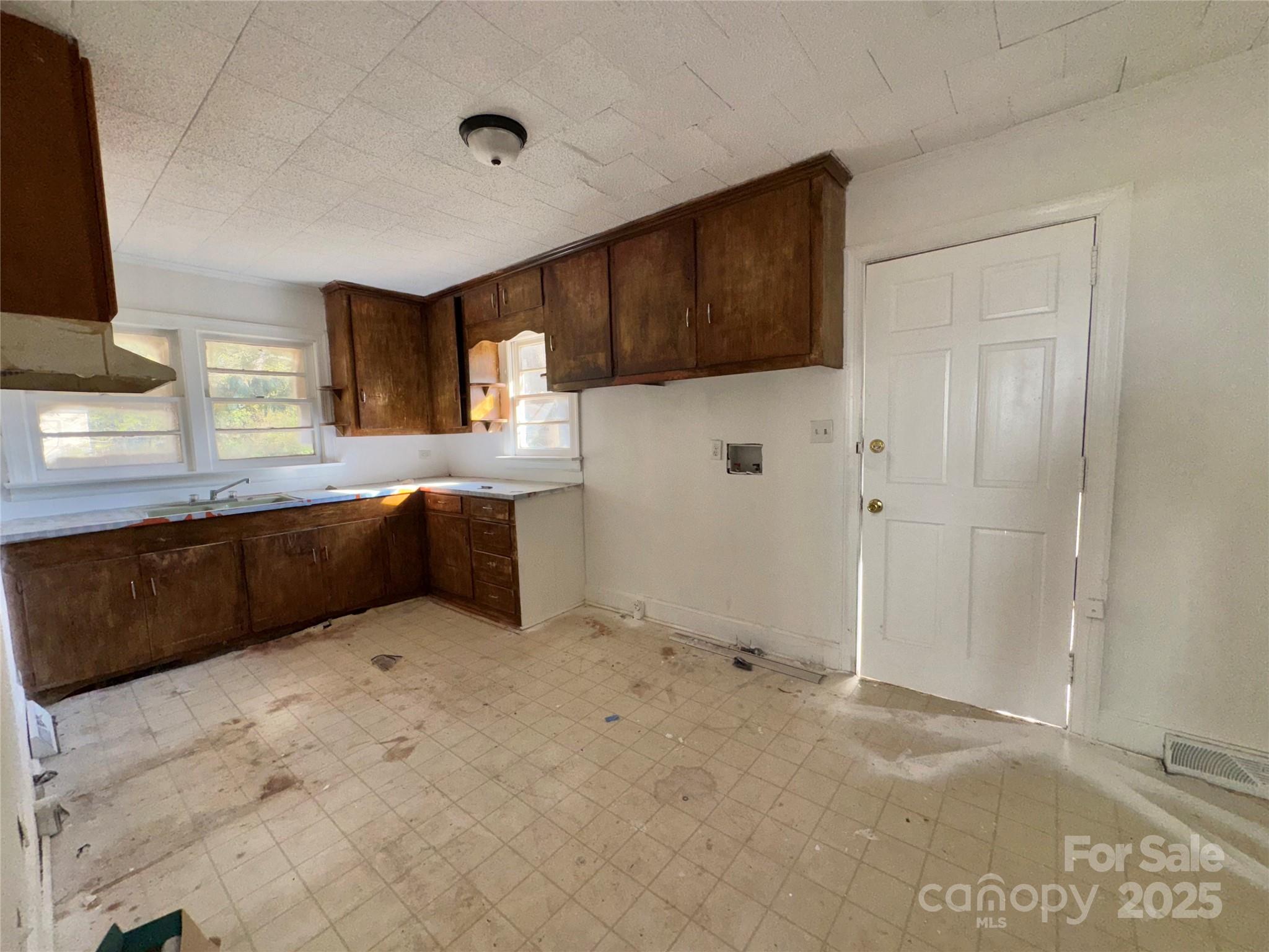 1224 Bailey Street Albemarle, NC 28001 - Photo 8 of 23 a kitchen with stainless steel appliances a sink and a refrigerator