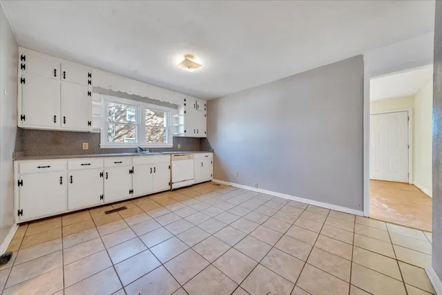 a view of a kitchen with white cabinets
