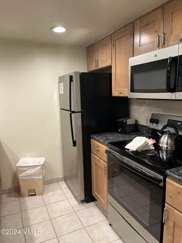 a kitchen with a sink and a stove top oven