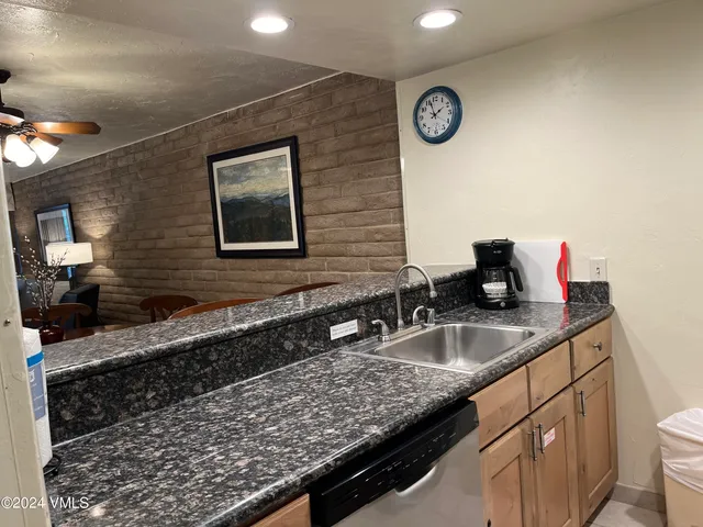 a bathroom with a granite countertop sink and a granite top