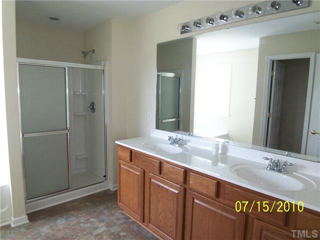4345 Karlbrook Lane Raleigh, NC 27616 - Photo 7 of 12 a bathroom with a sink and a mirror