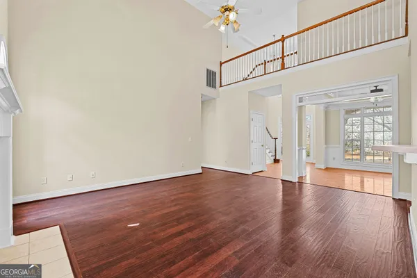 a view of empty room with wooden floor
