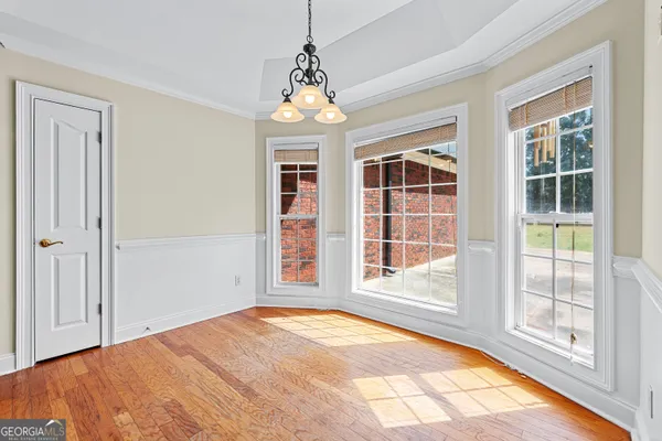 a kitchen with stainless steel appliances granite countertop a stove a sink dishwasher a refrigerator and a microwave oven with wooden floor