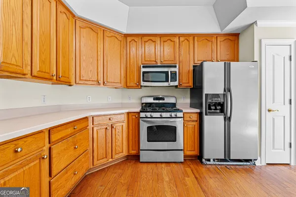 a kitchen with stainless steel appliances granite countertop a sink and dishwasher