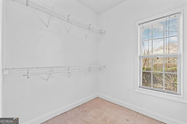 a view of a hallway with wooden floor and stairs