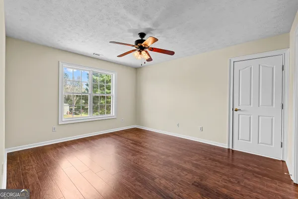 a view of a livingroom with a fireplace wooden floor and a fireplace