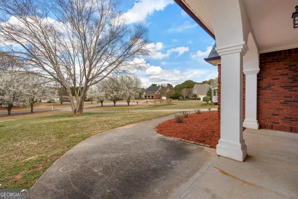 a view of an entryway with wooden floor and door