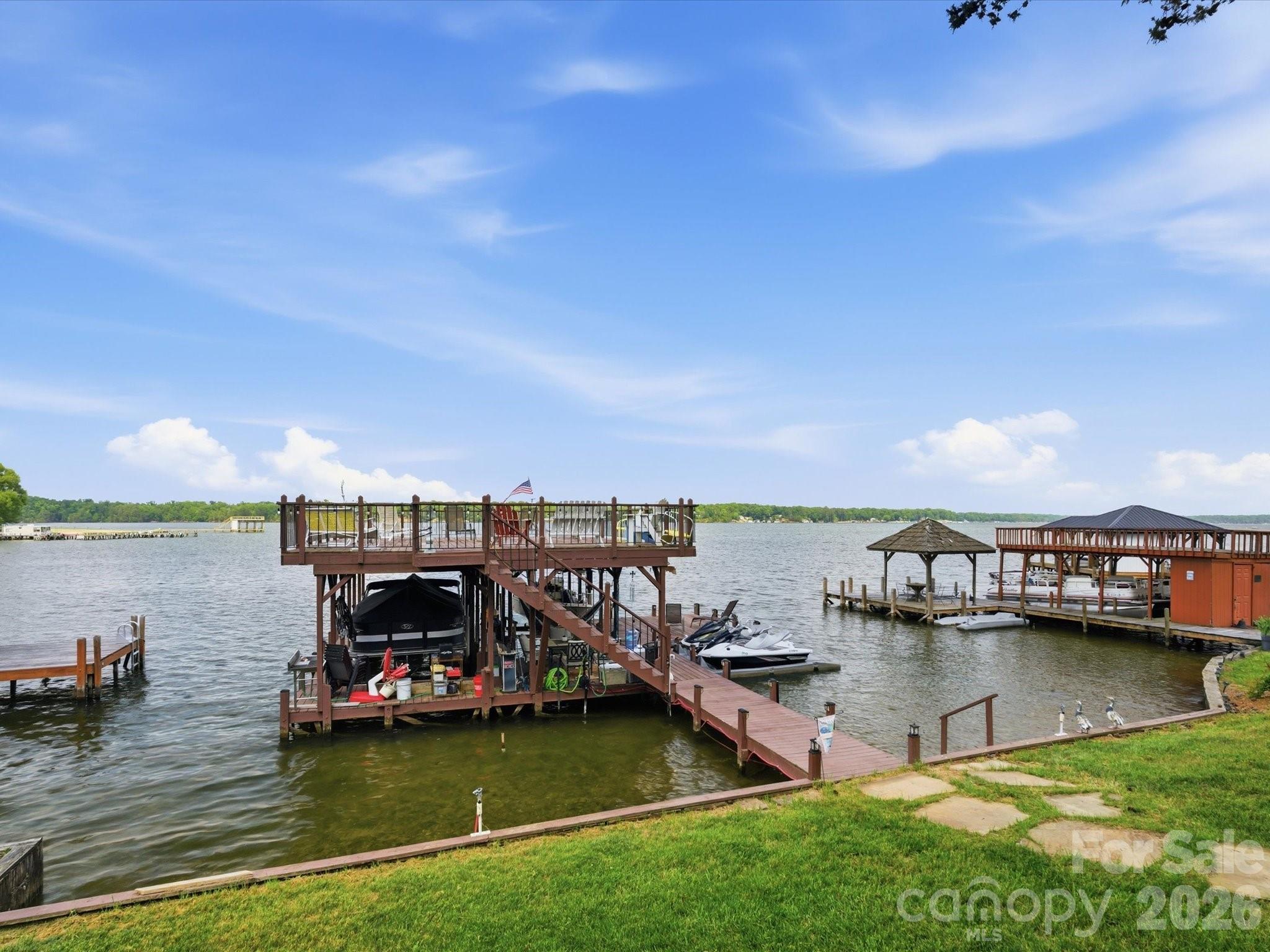 562 Lake Head Road Norwood, NC 28128 - Photo 26 of 43 a view of a lake with boats and trees