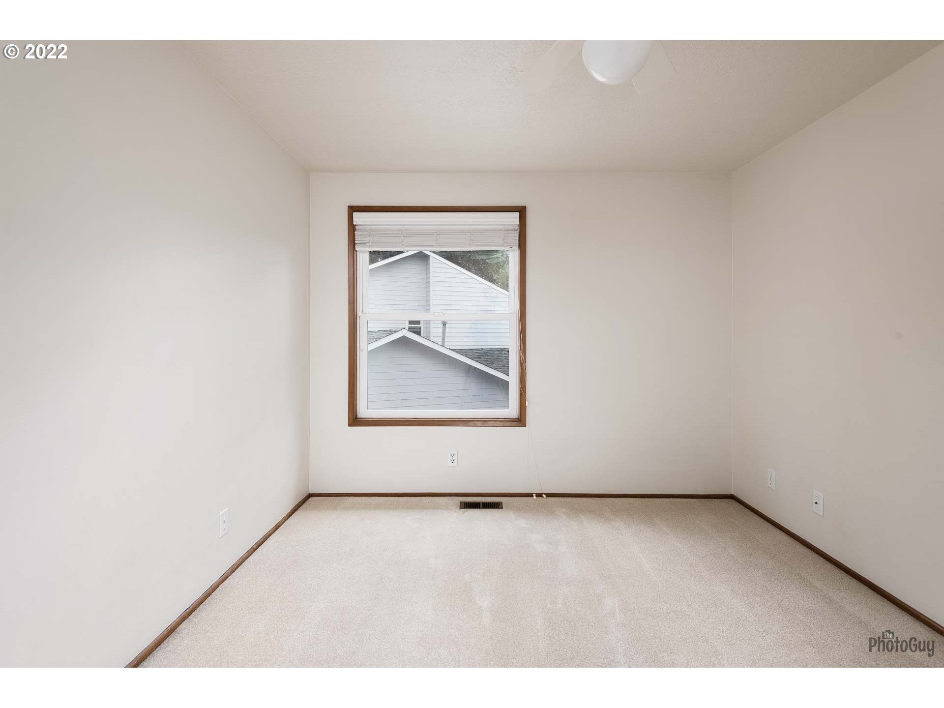 589 Granite Place Springfield, OR 97477 - Photo 17 of 31 a view of an empty room with wooden floor and a window