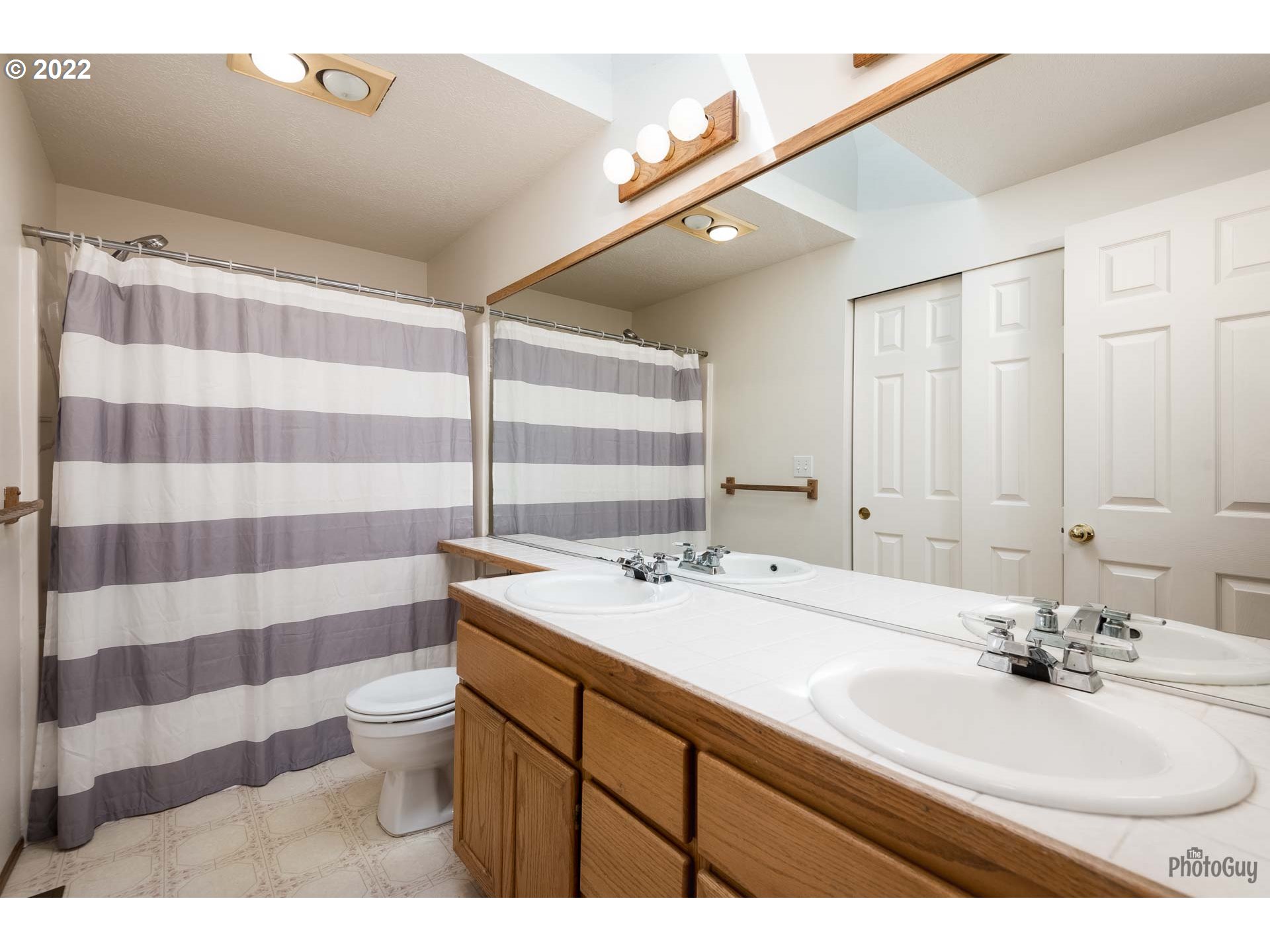 589 Granite Place Springfield, OR 97477 - Photo 23 of 31 a bathroom with a sink a toilet a mirror and shower curtain