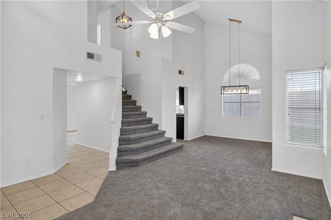 3156 Terrace View Drive Laughlin, NV 89029 - Photo 9 of 94 A spacious living area with soaring ceilings and a graceful staircase creates an inviting atmosphere.