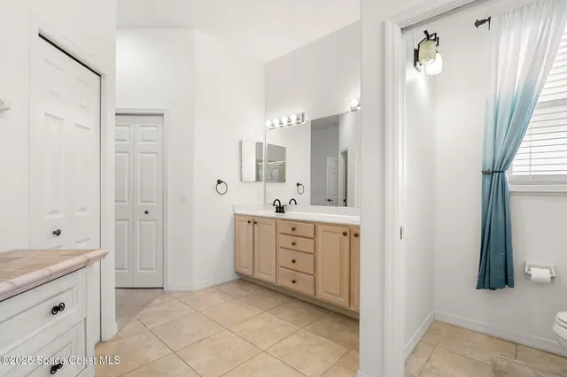 a spacious bathroom with a granite countertop sink mirror and a